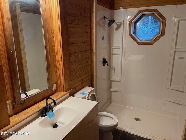 bathroom with vanity, a shower stall, and toilet