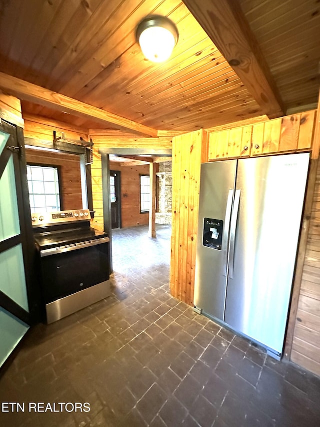 kitchen featuring wooden walls, stainless steel appliances, wooden ceiling, and a wealth of natural light