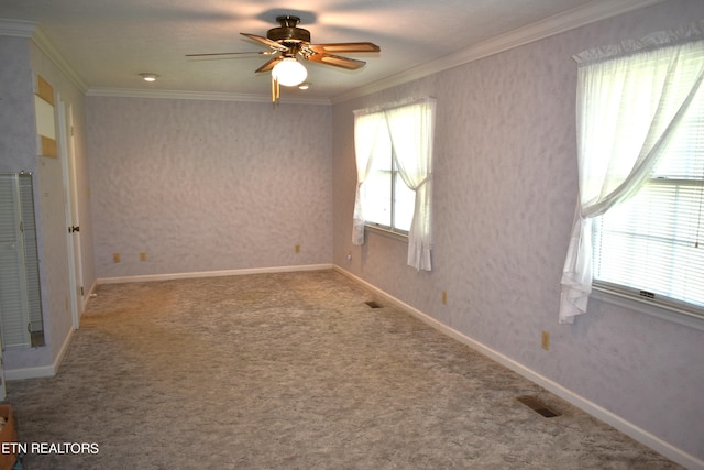 carpeted empty room with ornamental molding, visible vents, and wallpapered walls