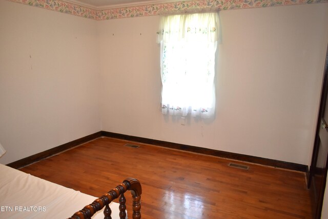 empty room with wood-type flooring