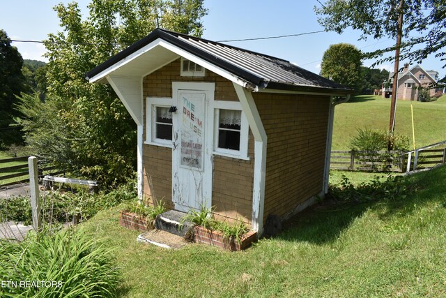 view of outbuilding with a yard