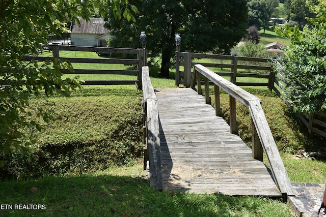 view of dock featuring fence and a yard