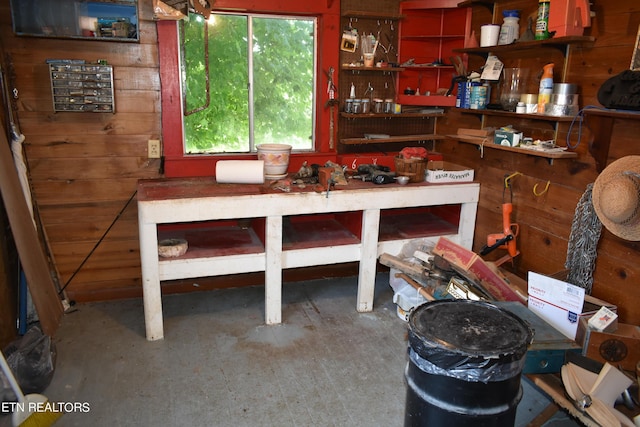 interior space with wooden walls and a workshop area