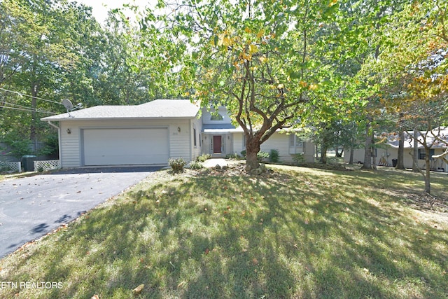 view of front of property with a garage, a front lawn, and aphalt driveway