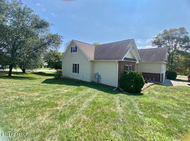 view of side of property with a yard