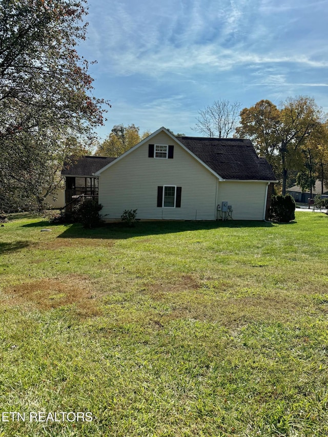 view of property exterior featuring a lawn