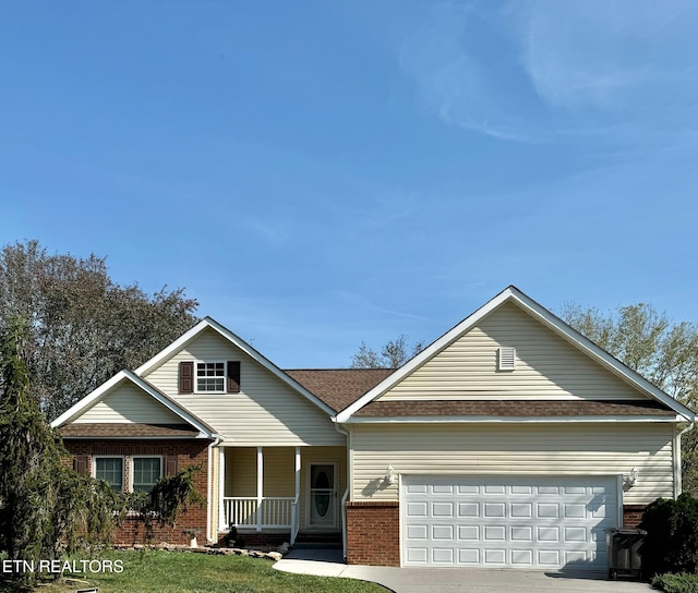 view of front of house featuring covered porch, concrete driveway, brick siding, and a garage