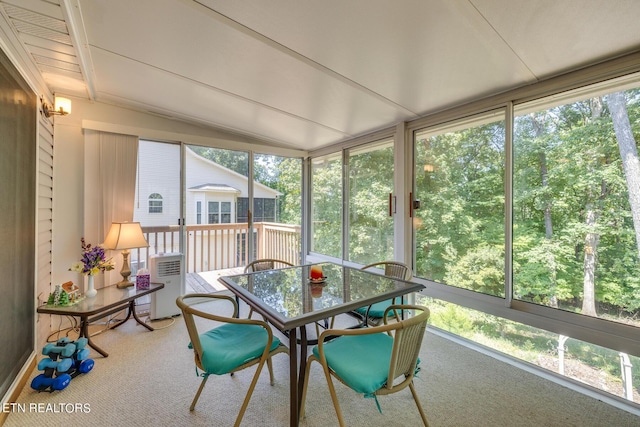 sunroom / solarium featuring lofted ceiling