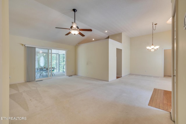 unfurnished room featuring high vaulted ceiling, light colored carpet, and ceiling fan with notable chandelier