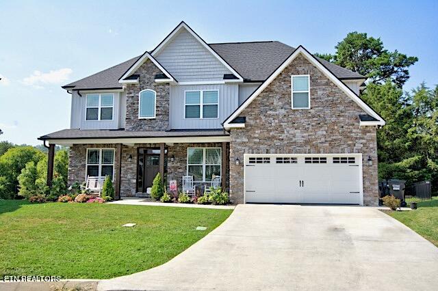 12742 Myrtle Ridge Ln, Knoxville, TN 37932 - craftsman house with an attached garage, a front yard, board and batten siding, driveway, and a porch