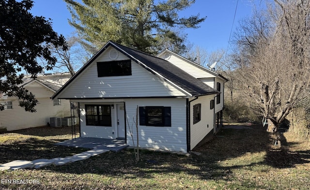 view of front of property with a patio area and central AC