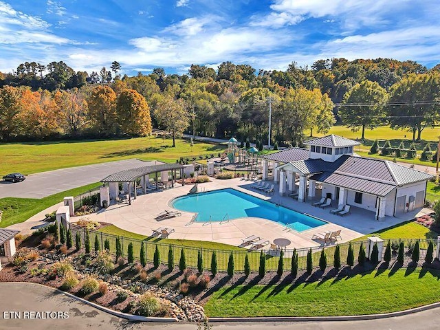 view of swimming pool featuring a patio, a pergola, and a lawn