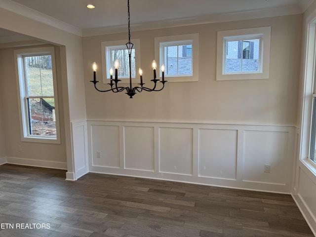 unfurnished dining area featuring dark hardwood / wood-style flooring and ornamental molding