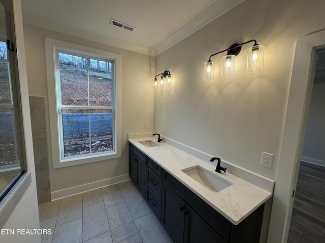 bathroom with vanity, tile patterned flooring, and crown molding