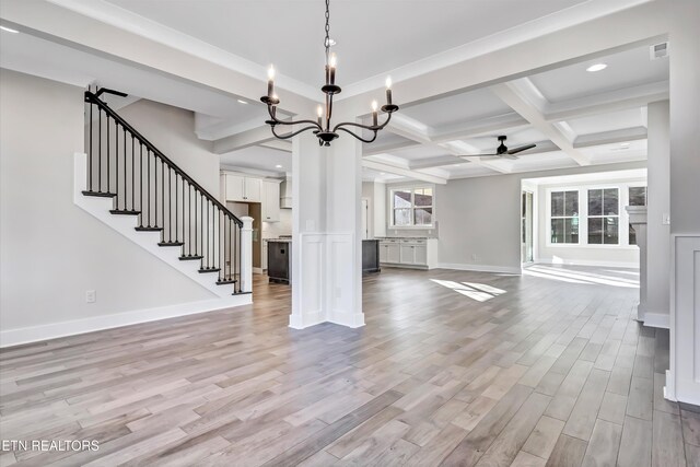 unfurnished living room featuring baseboards, coffered ceiling, beam ceiling, light wood-style flooring, and ceiling fan with notable chandelier