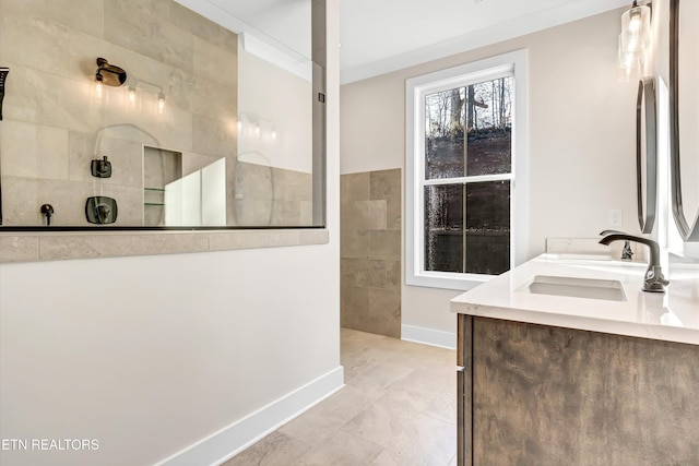 full bathroom with double vanity, ornamental molding, a sink, walk in shower, and tile walls