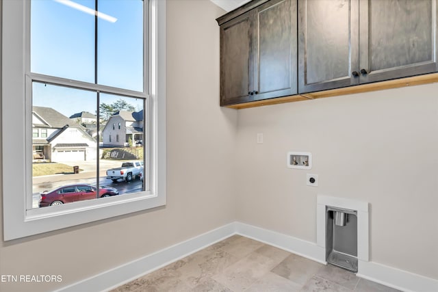 washroom with electric dryer hookup, baseboards, cabinet space, and washer hookup