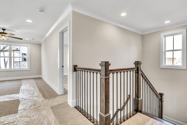 hallway with baseboards, recessed lighting, ornamental molding, carpet flooring, and an upstairs landing