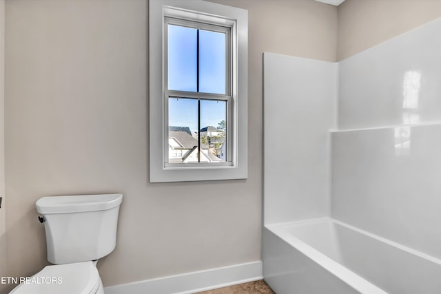 bathroom with toilet and baseboards