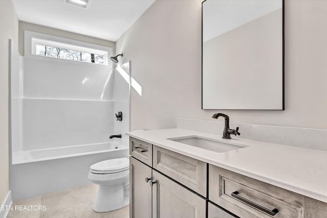 bathroom featuring vanity, shower / tub combination, and toilet