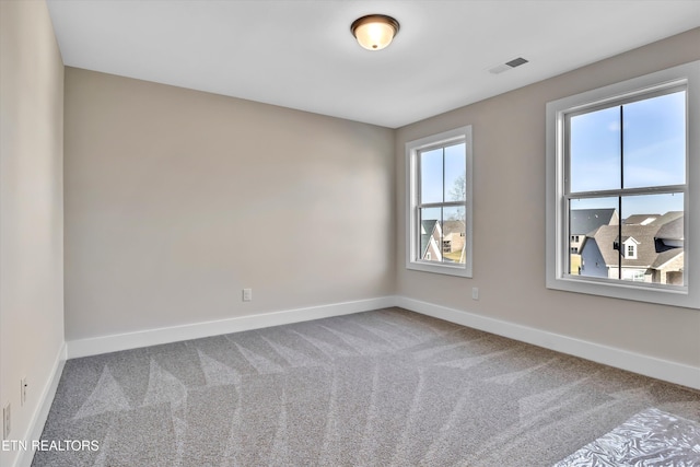 unfurnished room with visible vents, carpet flooring, and baseboards