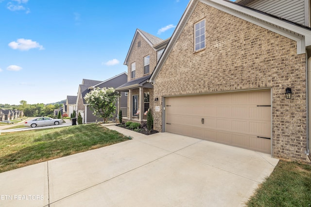 view of front of home with a garage and a front lawn