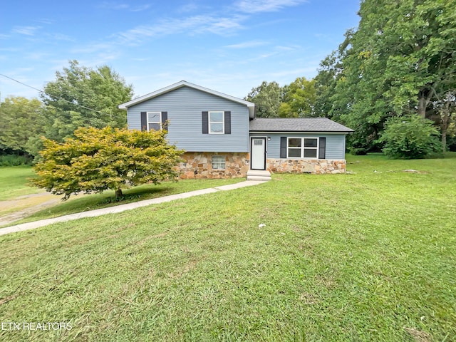 tri-level home with a front yard