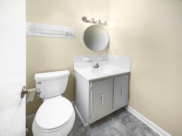 bathroom featuring toilet, vanity, and tile patterned floors