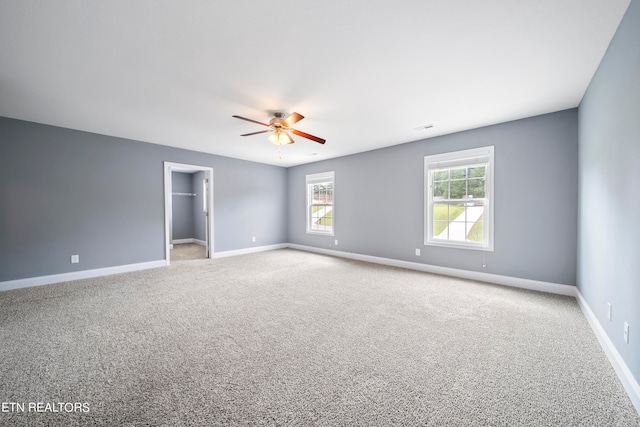 empty room with carpet flooring and ceiling fan