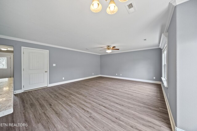 unfurnished living room with hardwood / wood-style flooring, crown molding, and ceiling fan