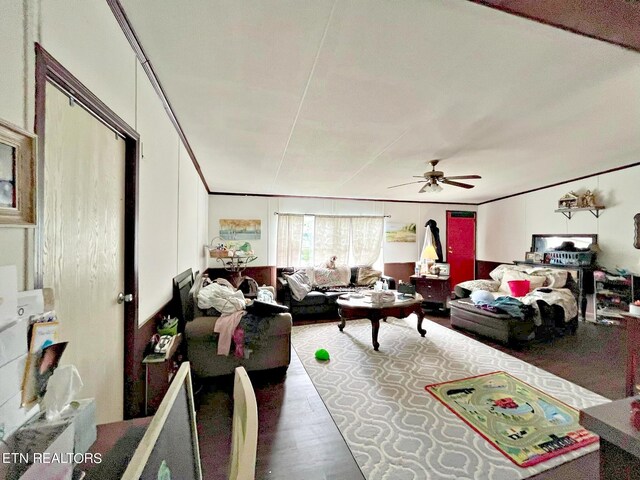 living room featuring ceiling fan, hardwood / wood-style flooring, and ornamental molding