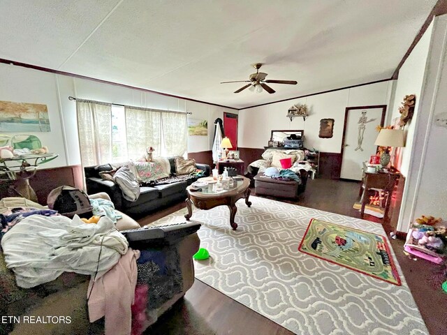 living room featuring ceiling fan, crown molding, and wood-type flooring