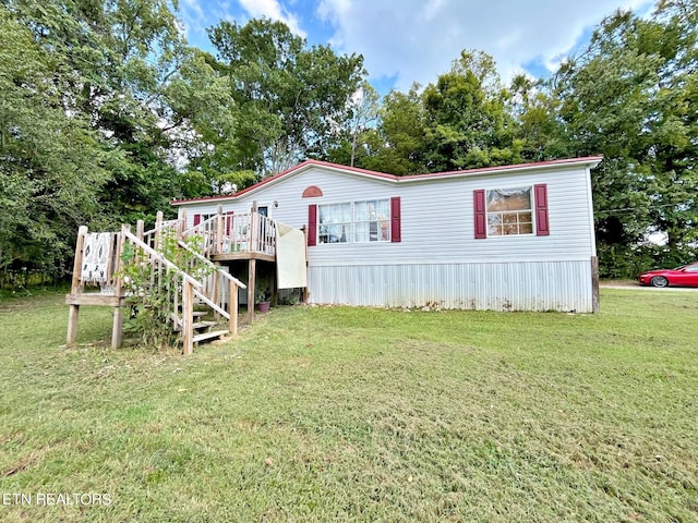 view of front of house featuring a deck and a front yard