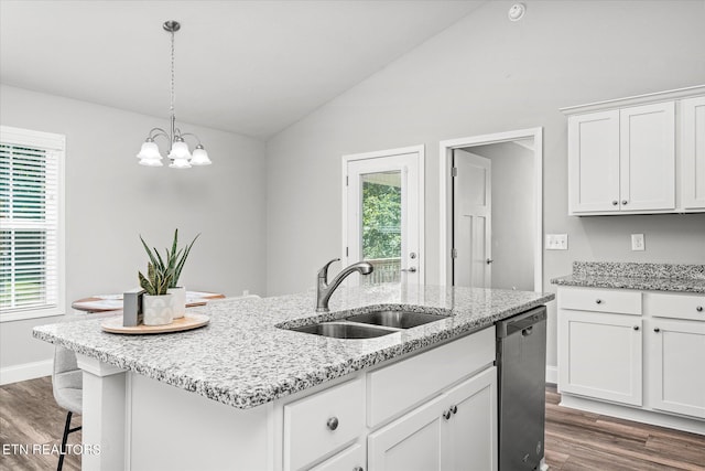 kitchen with lofted ceiling, an island with sink, stainless steel dishwasher, white cabinetry, and a sink