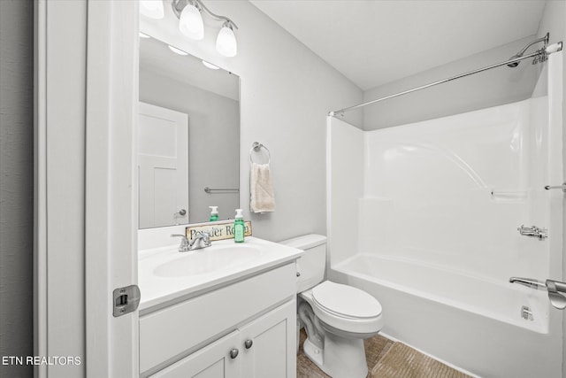 bathroom featuring washtub / shower combination, vanity, and toilet