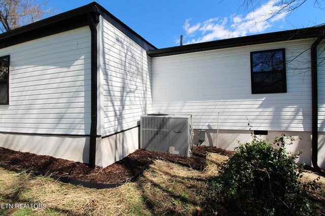 view of side of home with cooling unit