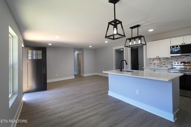 kitchen with dark hardwood / wood-style flooring, decorative backsplash, sink, and appliances with stainless steel finishes