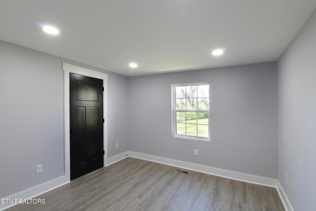 unfurnished bedroom featuring hardwood / wood-style floors and a closet