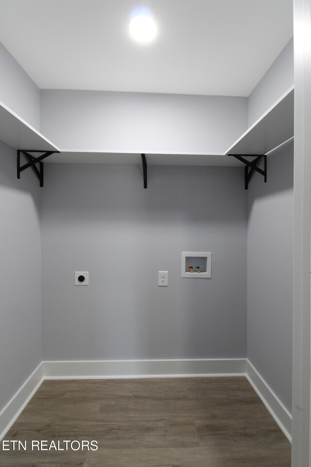 clothes washing area featuring hardwood / wood-style flooring, electric dryer hookup, and hookup for a washing machine