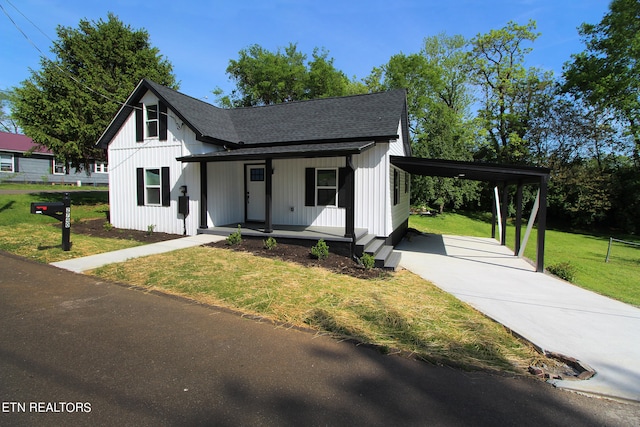 modern inspired farmhouse featuring a carport, a porch, and a front lawn