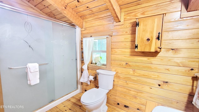 bathroom with wood ceiling, hardwood / wood-style floors, vaulted ceiling with beams, toilet, and wood walls