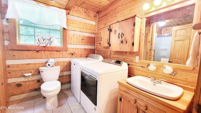 bathroom with vanity, wooden walls, tile patterned flooring, washing machine and dryer, and wood ceiling