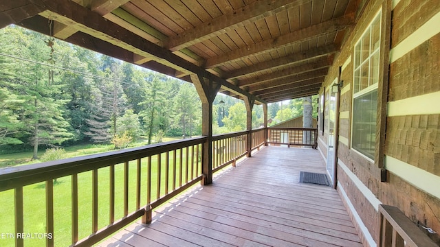 wooden terrace with a yard