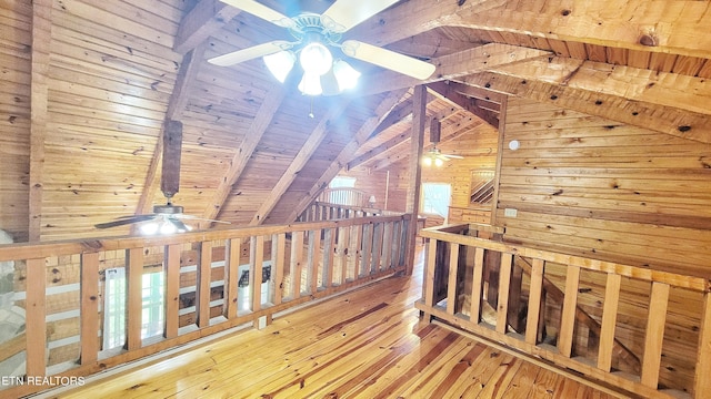 corridor featuring vaulted ceiling with beams, wood walls, wood-type flooring, and wood ceiling