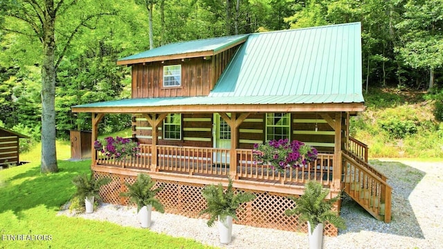 view of outbuilding with a yard and a porch