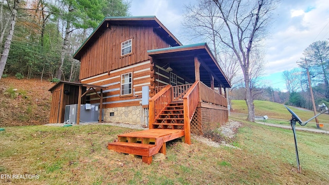 exterior space with a deck and a lawn