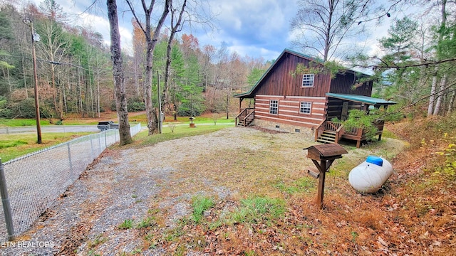 view of side of home featuring a wooden deck