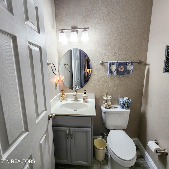 bathroom featuring toilet and vanity