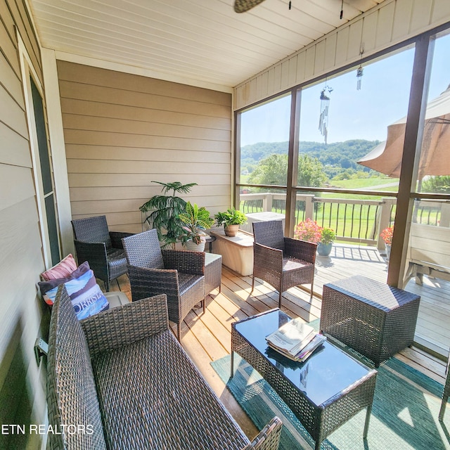 sunroom / solarium with a mountain view