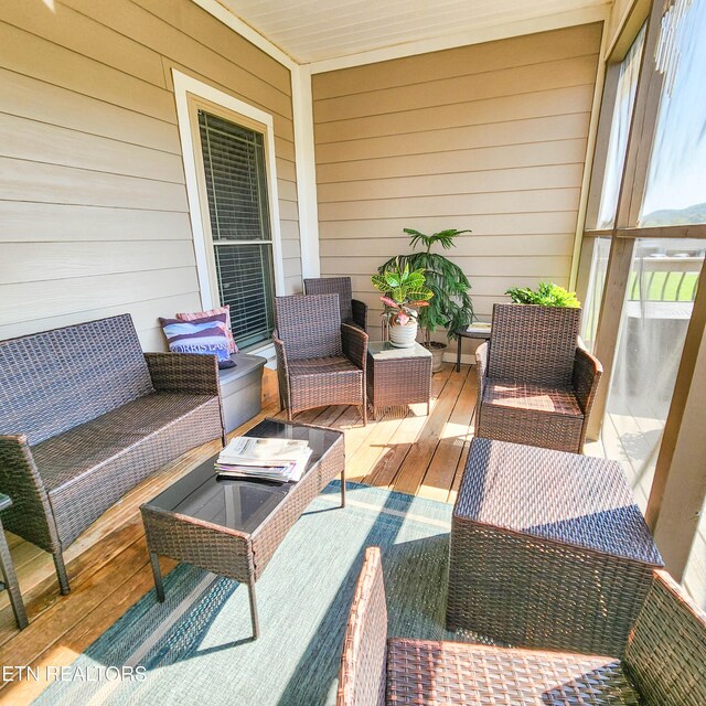 wooden terrace featuring outdoor lounge area